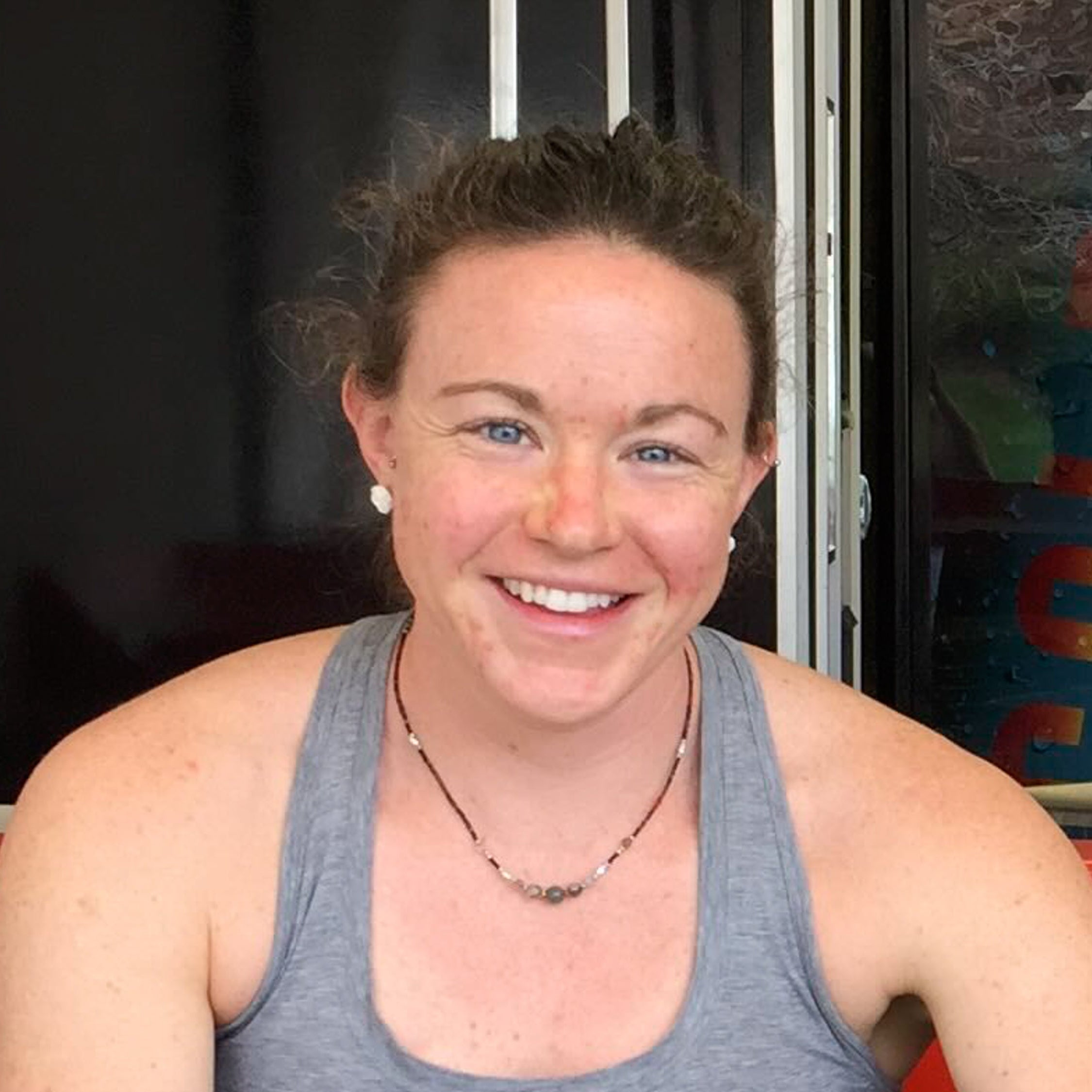 A woman smiling who gave the glass memorial pendants as a gift